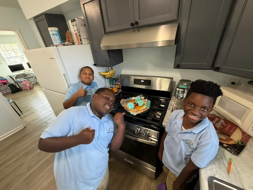 Students show their Earth science pizza project